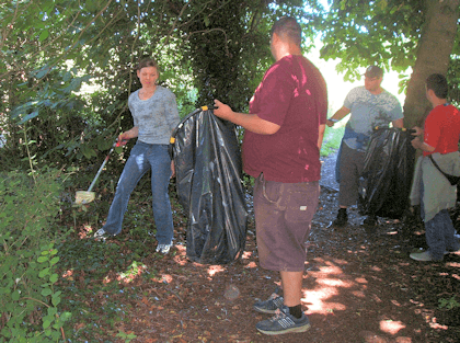 Volunteers picking up litter in local woodlands.