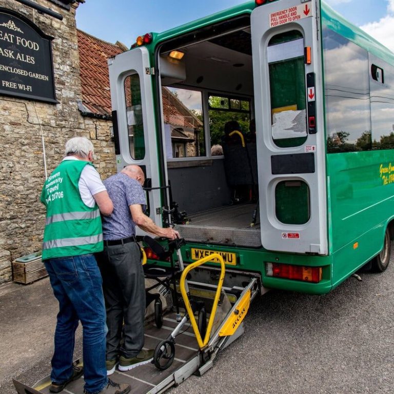 A Green Community Transport volunteer A Green Community Transport volunteer driver helps a man into the minibus.
