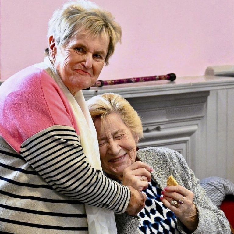 A volunteer at a local stroke support group A volunteer interacts with a woman in a local stroke support group.